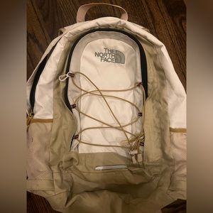 White and tan North Face backpack in used but good condition